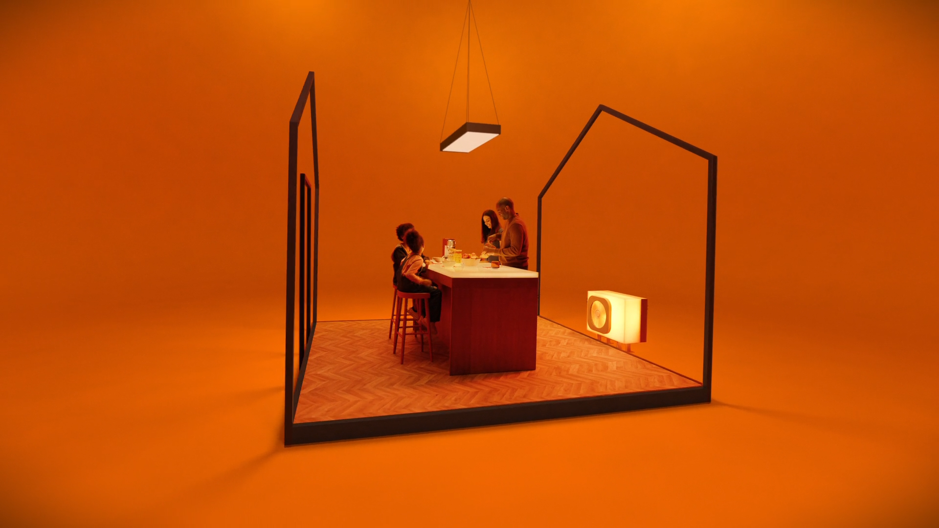 orange studio setup with 2 people sitting at a desk